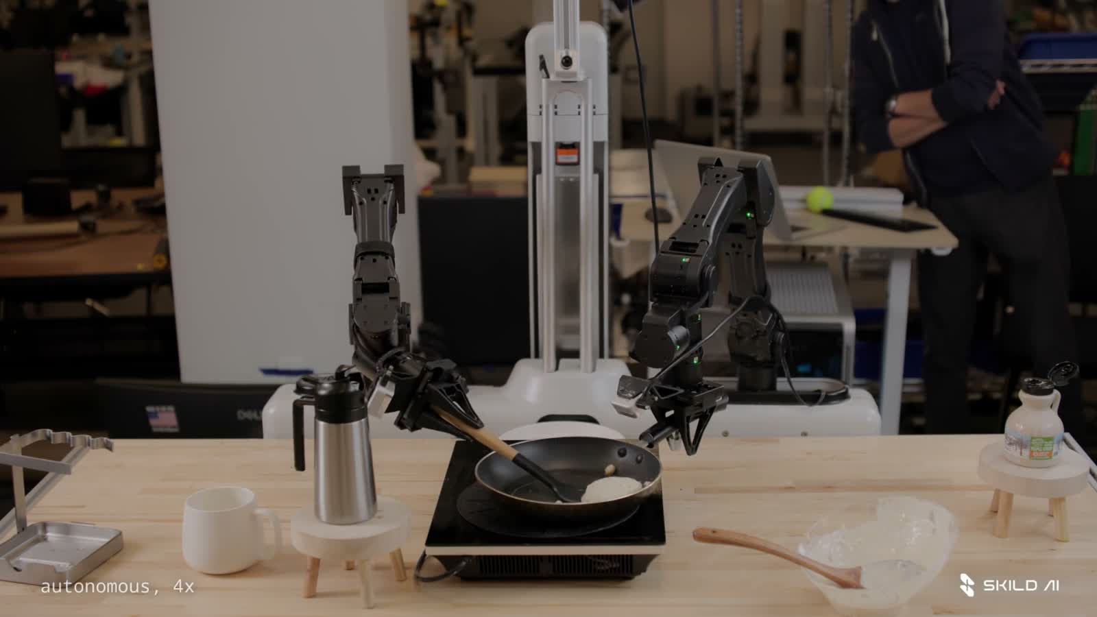 Skild robot arms cooking a pancake; original demonstration is labeled 4× speed