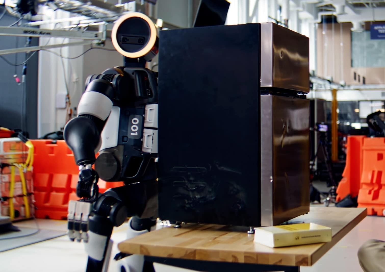 Atlas humanoid carrying a mini-fridge in a Boston Dynamics demonstration
