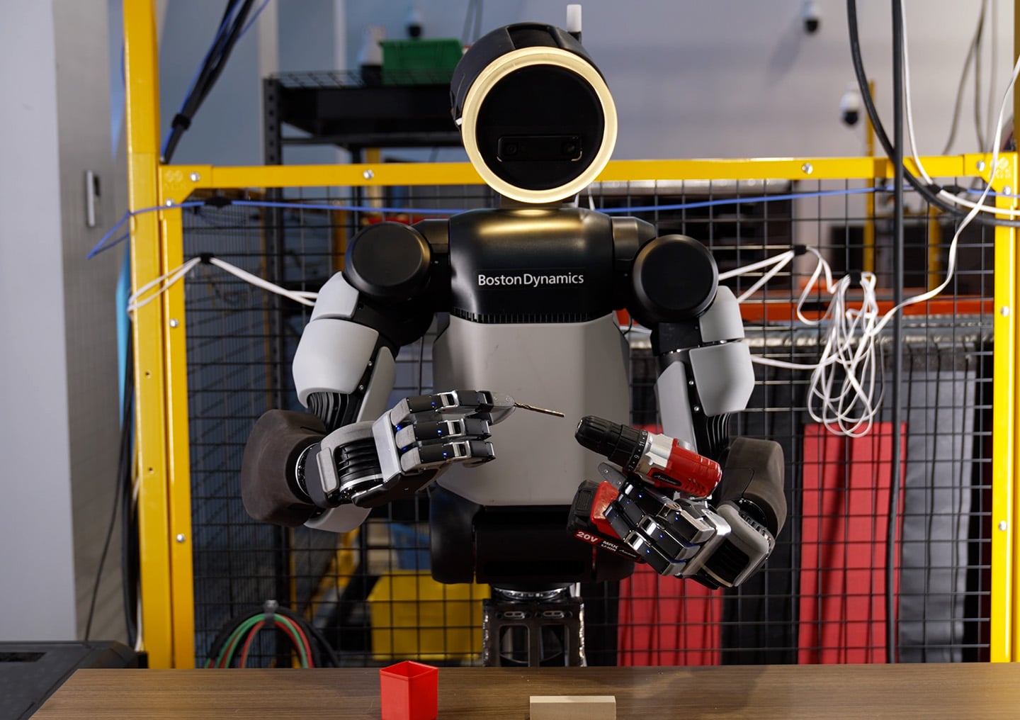 Boston Dynamics Atlas robot placing a drill bit into a drill with its new hand.