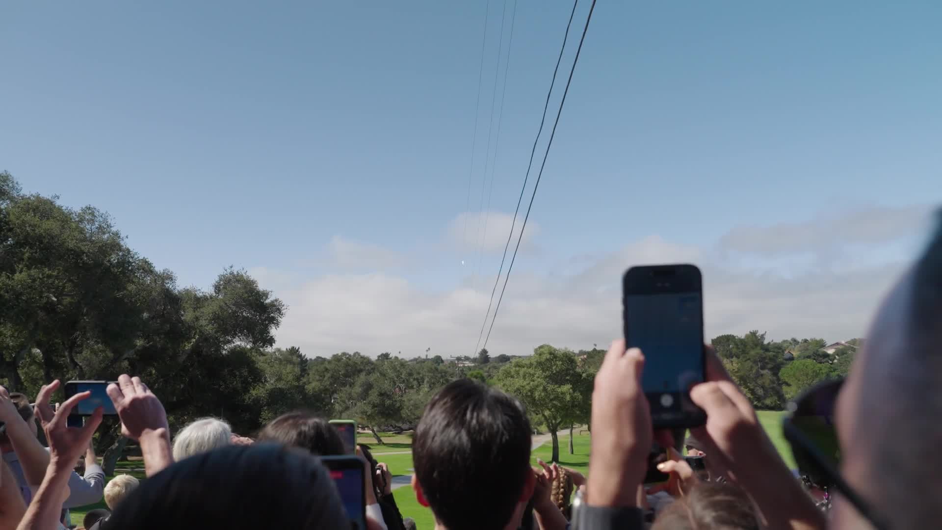 People watching a rocket launch on a phone, in Google’s Project Suncatcher source image.